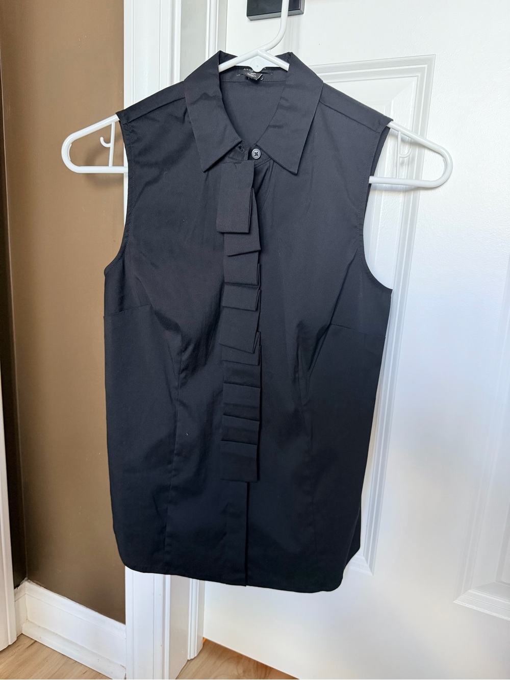 Sleeveless Black Ruffle Front Blouse